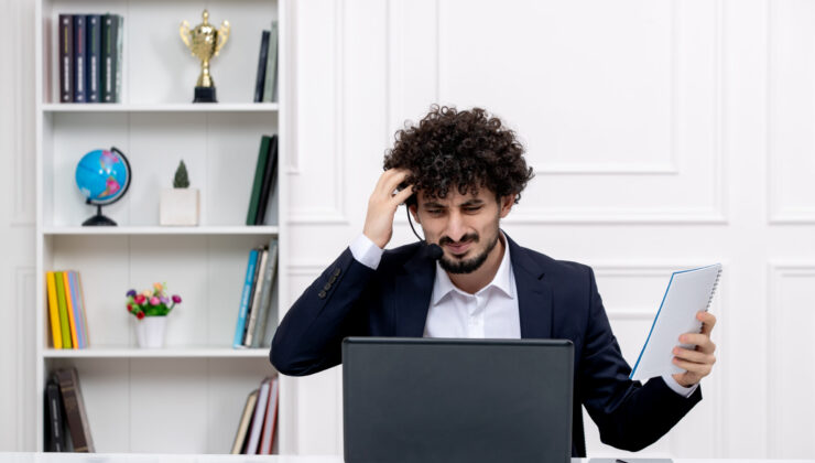 customer-service-cute-brunette-guy-office-suit-with-computer-headset-confused-touching-head 7 Mistakes Indians Make Applying for Jobs in Europe