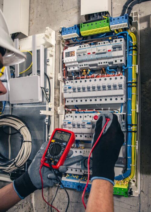man-electrical-technician-working-switchboard-with-fuses (3) (1)